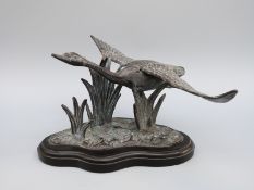 A bronze or similar model of a swan in flight,