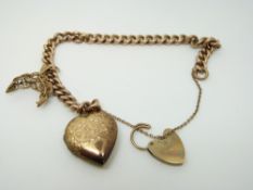 A 9ct gold curb link bracelet with a heart padlock