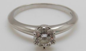 A Tiffany & Co platinum ring set with a round brilliant cut diamond of approximately 0.