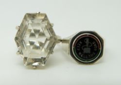 A silver ring set with a six sided mixed cut quartz and a silver ring set with enamel reading 'keep