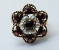 A 9ct gold ring set with pearls and garnets (size M)