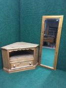 A pine corner TV stand with a pine framed hall mirror