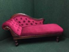 A Victorian chaise longue in burgundy buttoned fabric