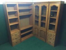 A contemporary oak four section bookcase (two sections with glazed doors,