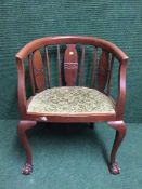 An early 20th century mahogany tub chair on claw and ball feet