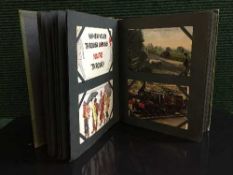 A postcard album containing various cards including monochrome images,