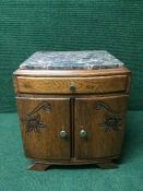 A continental oak double door marble topped bedside cabinet