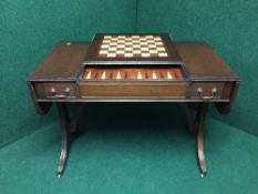 A mahogany drop end sofa table with chess board top with a backgammon board
