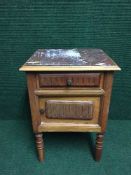 A walnut marble topped bedside cabinet