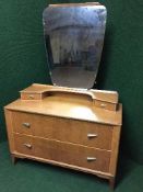 A mid 20th century oak dressing chest with shaped mirror