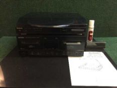 A Technics automatic turn table, model SL-J110R together with a Technics double cassette deck,
