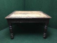 An early 20th century square pine table