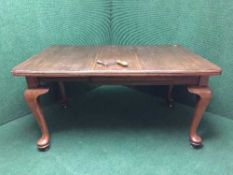 A Victorian mahogany wind out dining table with leaf and winder