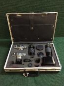 A case containing two Olympus OM1 and OM2 cameras with lenses and accessories