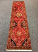 A Persian Kashgai runner, with central medallions and flowerhead borders,