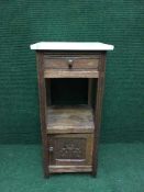 A continental oak marble topped cabinet fitted with a drawer