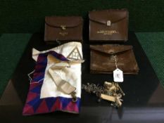 A basket of three masonic bags and regalia