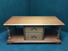 An oak two tier storage coffee table fitted two drawers