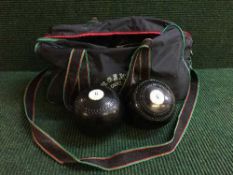 A bowls bag containing a set of four Jack Finder bowls