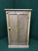 A pine single door cupboard