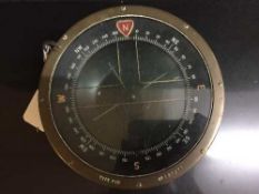 A circular brass ship's compass type P10