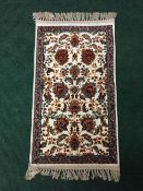 A fringed Persian rug with silk pile, 95cm by 50cm.