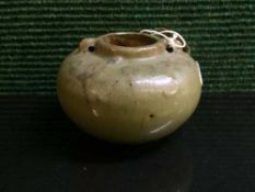 A Chinese green glaze eathenware twin handled bowl, in the Song style and probably of the period,