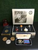 A boxed set of Mercedes Benz branded wine stoppers, TSB money bank and coins,