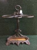 A wrought iron stick stand with lift out tray