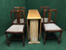 An oak drop leaf table and four chairs