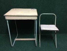 A mid 20th century child's desk with folding chair