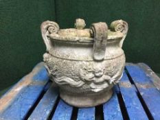 A stone garden cherub planter