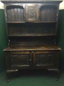 A 19th century heavily carved oak dresser on cabriole legs
