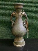 A Chinese patinated bronze archaic twin handled vase,