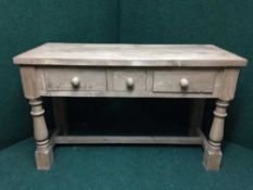 A reclaimed pine three drawer farmhouse table