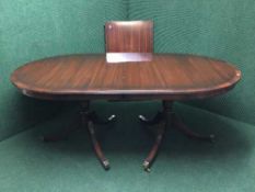 An inlaid mahogany Regency style twin pedestal table and a leaf