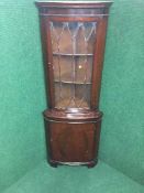 A mahogany corner display cabinet