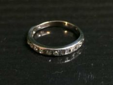 An 18ct white gold diamond set half eternity ring, 4.