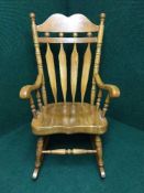 A contemporary high backed rocking chair