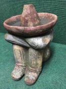 A terracotta garden figure - sleeping Mexican