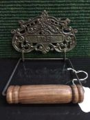 A reproduction metal toilet roll holder