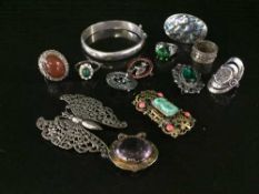 A collection of silver/white metal dress rings, silver bangle,