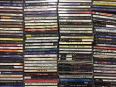 A box of cd's together with a wireless keyboard and optical mouse and cd rack