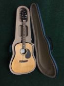 A Encore acoustic guitar in carry case