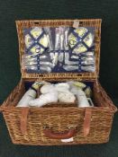 A wicker basket containing picnic set