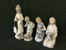 A Nao figure - Girl in night dress with dog together with three other Nao children figures