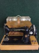 A Singer sewing machine together with a concertina sewing box