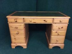 A pine twin pedestal leather topped desk