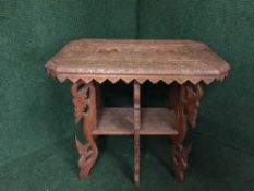 A heavily carved oak occasional table
