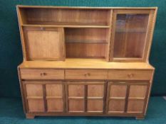A mid 20th century teak sideboard fitted a bureau